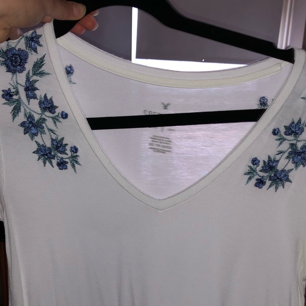 white t-shirt with embodied flowers